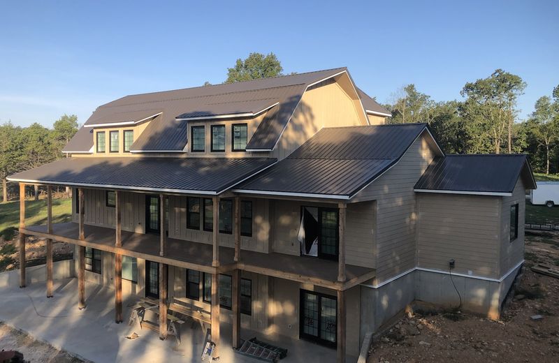 A large two-story home with stacked wraparound decks