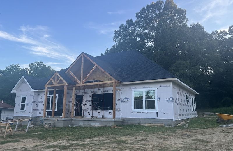 The front of a new house with timber porch brackets going on