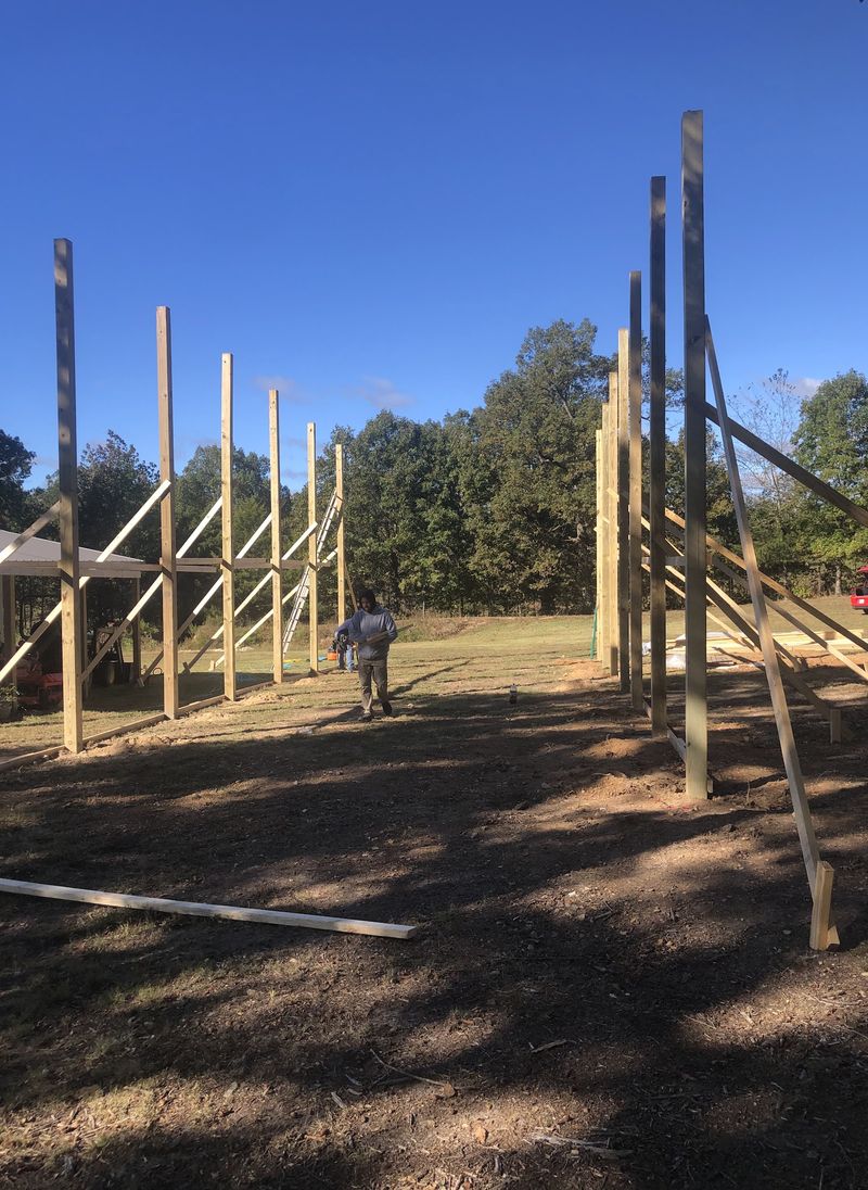 Posts set and braced at the start of a post-frame build