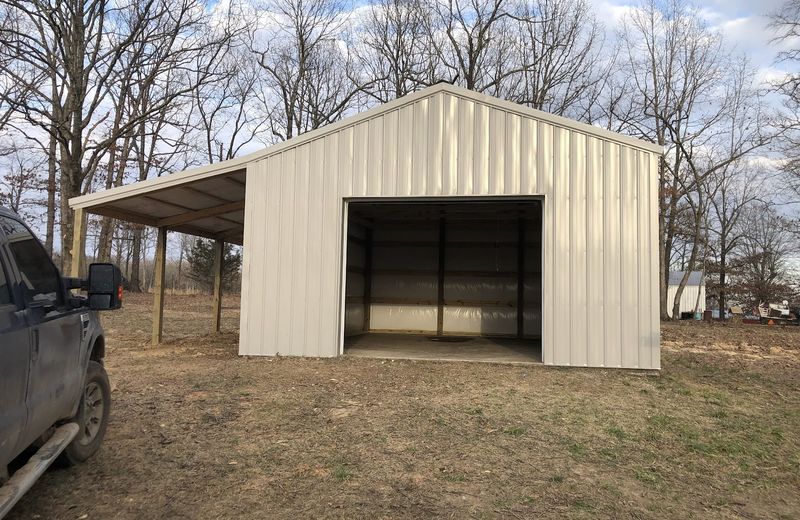 A post-frame shop building with metal siding and roof